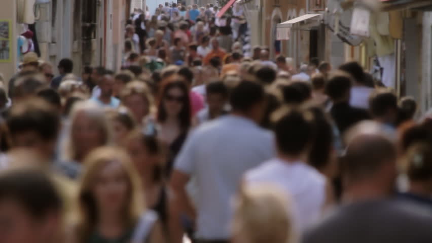 Crowd, unrecognizable people. Tourists walking in a narrow street in Porec, Croatia. 