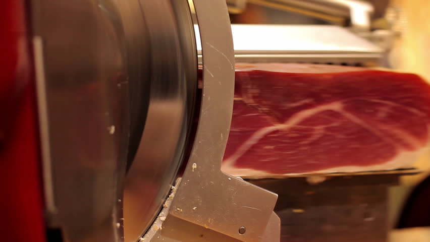 mechanical cutting jabugo ham in the shop