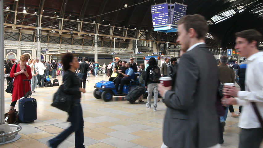 LONDON, UK - JULY 26: Train travelers walk through the central hall of Liverpool Street Station on July 26, 2011 in London, UK. Liverpool Street Station is the third busiest railway station of London.