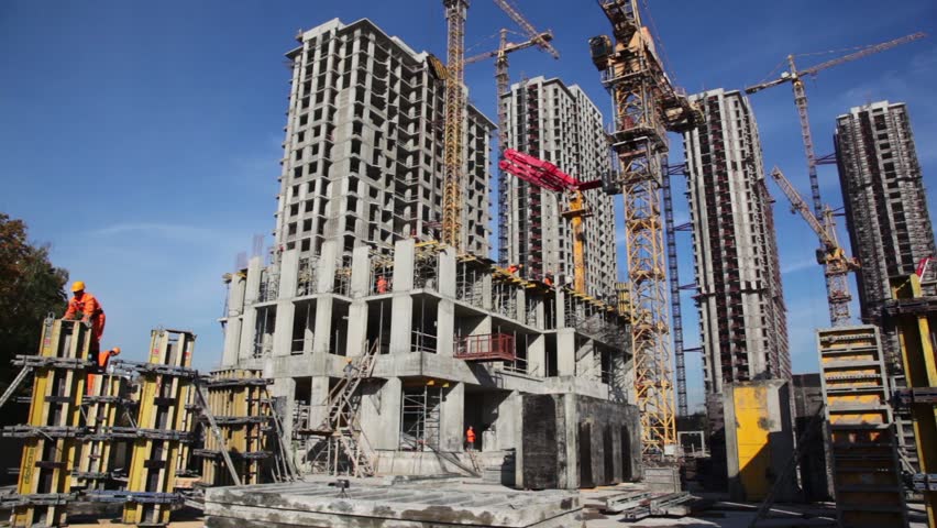 MOSCOW - SEPTEMBER 27: Builder works in front of many tall buildings under construction, September 27, 2010 in Moscow, Russia. otal investment in commercial real estate in Russia in January-June 2011 doubled in yearly terms reaching 1.77bn euros. 