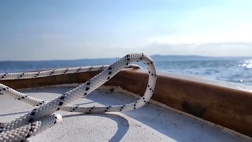 Small wooden boat on the blue sea