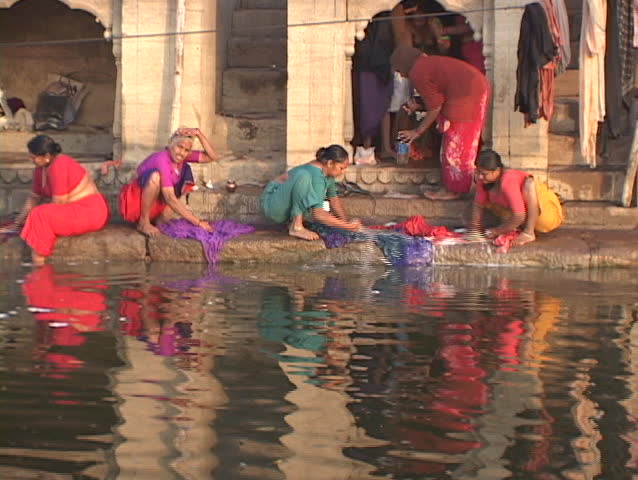 INDIA - CIRCA 2010: Women wash clothes in the Ganges River circa 2010 in India.