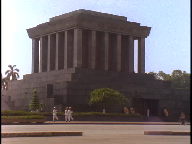 Pedestrians walk outside of the Ho Chi Minh Tomb in Hanoi, Vietnam.