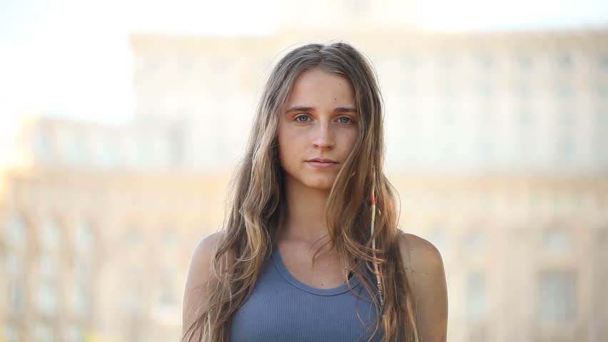 Attractive young adult lady air quotes with fingers. 