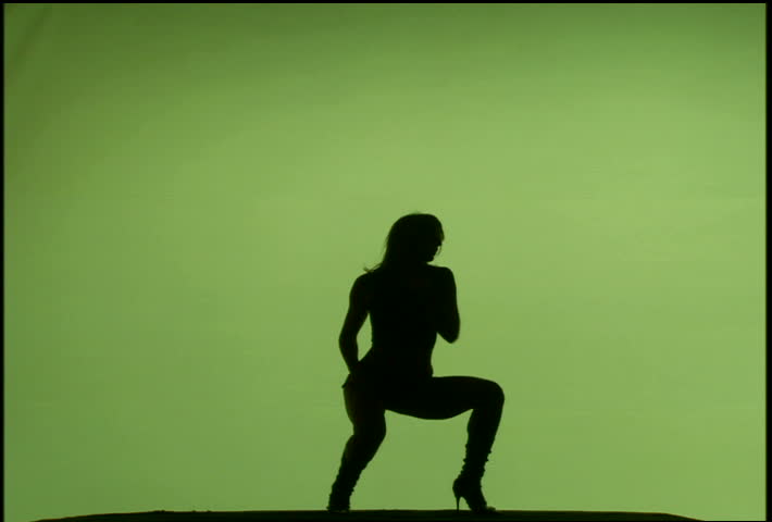 A woman's silhouette dancing against green background