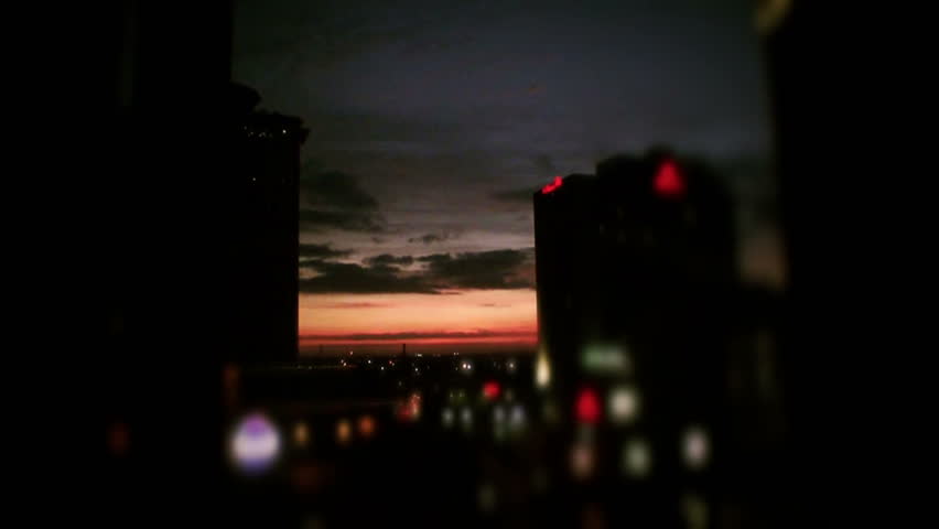 Time-lapse of sunrise/passing clouds btw. two buildings