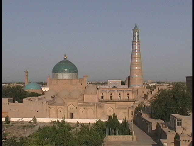 The Juma minaret and mosque domes adorn the blue sky.