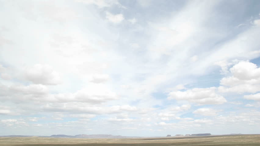 Time lapse shot of white clouds moving over the desert in Shiprock, New Mexico.