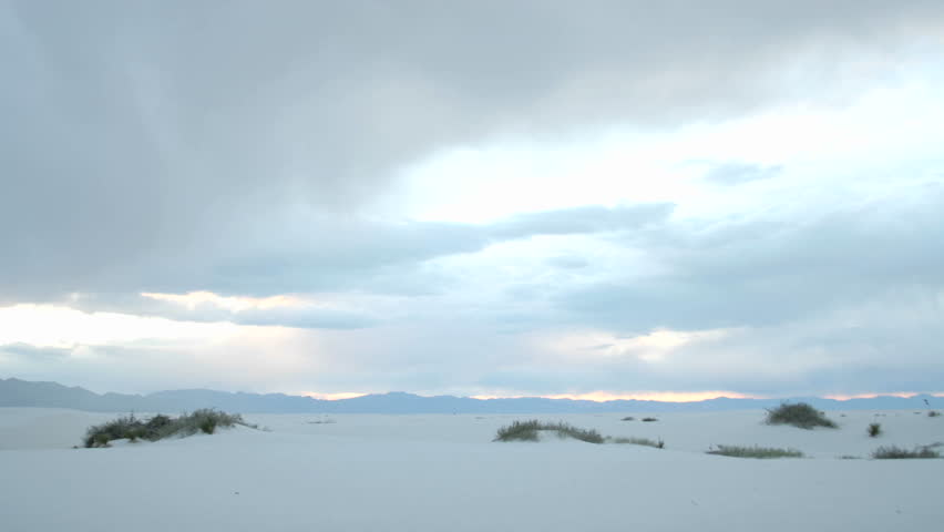 Time lapse shot clouds passing over White Sands National Monument throughout the day, and into the night.