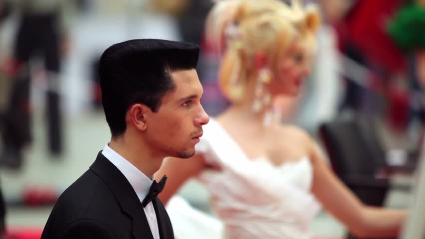MOSCOW - OCTOBER 2: Man in dark suit with platform hairstyle at XVII International Festival World of Beauty 2010 in exhibition complex Gostiny Dvor, on October 2, 2010 in Moscow, Russia.