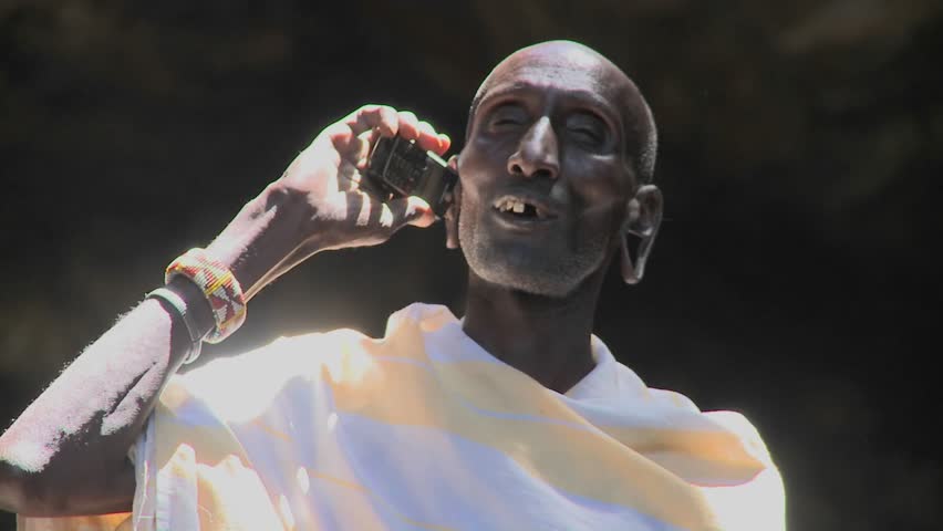 KENYA - CIRCA 2009: An old Masai man speaks to friends on a cell phone circa 2009 in Kenya.