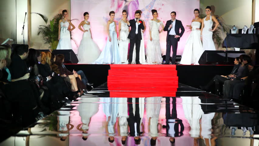 MOSCOW - FEBRUARY 14: Models in white wedding dresses stand on stage in front of catwalk at Evening of French fashion in salon Estet, on February 14, 2011 in Moscow, Russia.