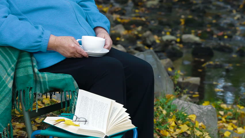 senior woman drinking coffee. Unrecognizable Person,  Side View