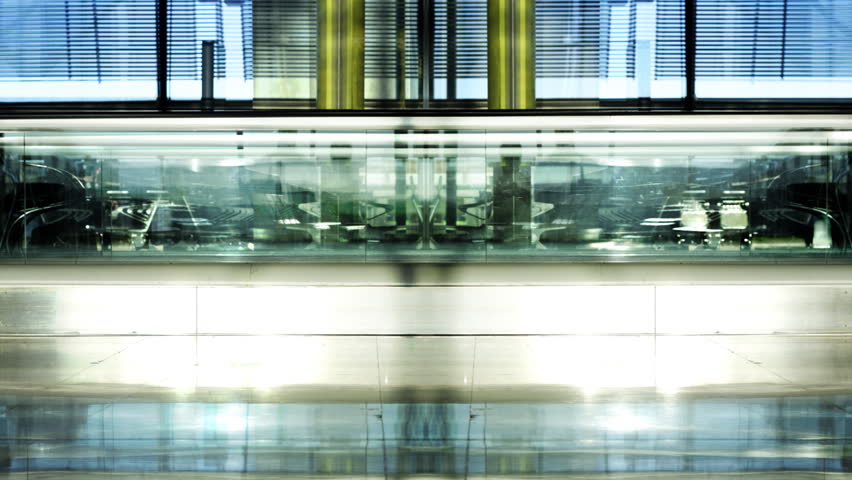 people at an airport on a travelator