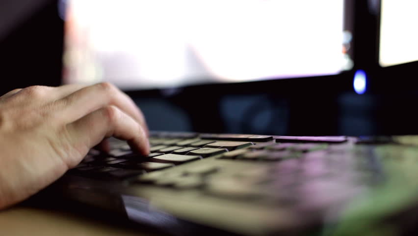 Fingers typing at desktop computer keyboard