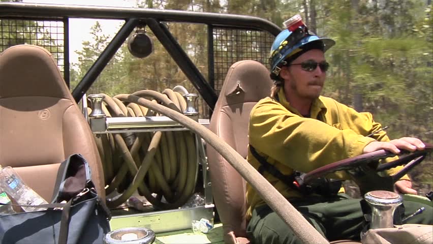 EVERGLADES, FL - CIRCA 2009: Firefighters drive a swamp buggy fire truck during  a prescribed fire circa 2009 in the Everglades.