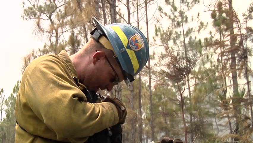 EVERGLADES, FL - CIRCA 2009: Firefighters fire a flare during a prescribed fire circa 2009 in the Everglades.