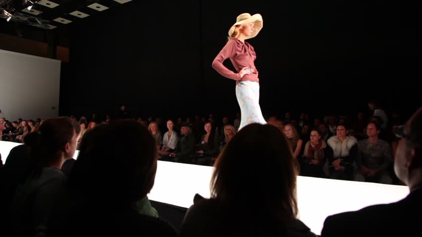 MOSCOW - NOVEMBER 19: Model in skirt, blouse and hat walk on podium at Russian Fashion Week, on November 25, 2010 in Moscow, Russia.
