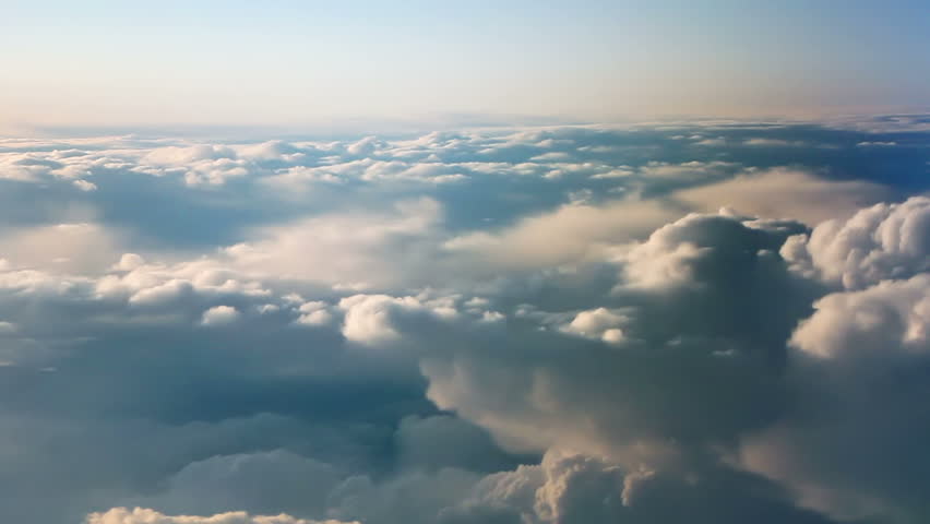 Aerial view of clouds over landscape from airplane.