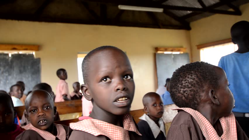 MASAI MARA, KENYA - OCTOBER 17: Unidentified schoolboys sit in a  school funded by tourists' donations on October 17, 2011 in Masai Mara, Kenya. 