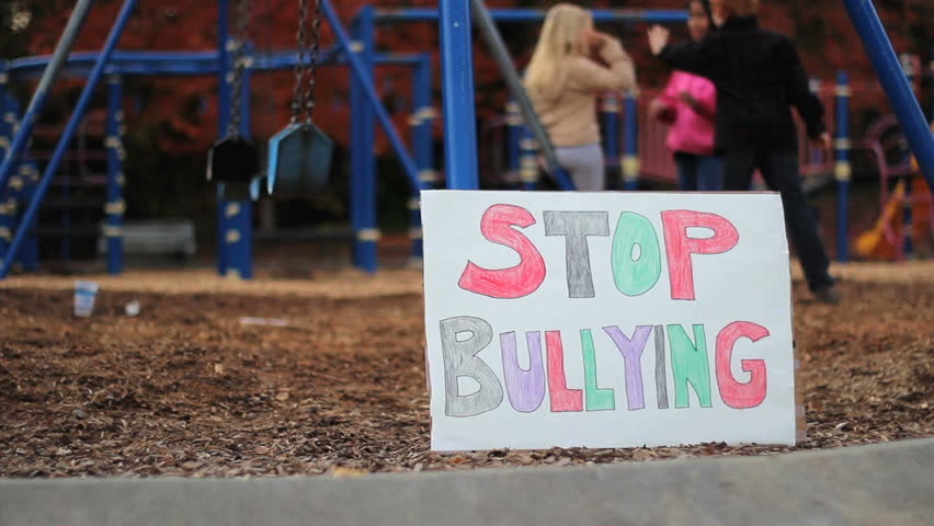 A frightened little Asian girl worries about being bullied at the local school yard by the bigger kids.