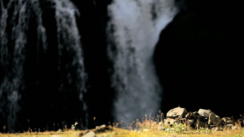 Young Hiker Viewing a Cascading Waterfall