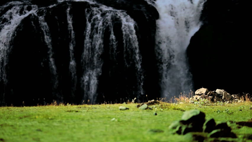 Lone Female on Hiking Expedition by Waterfall