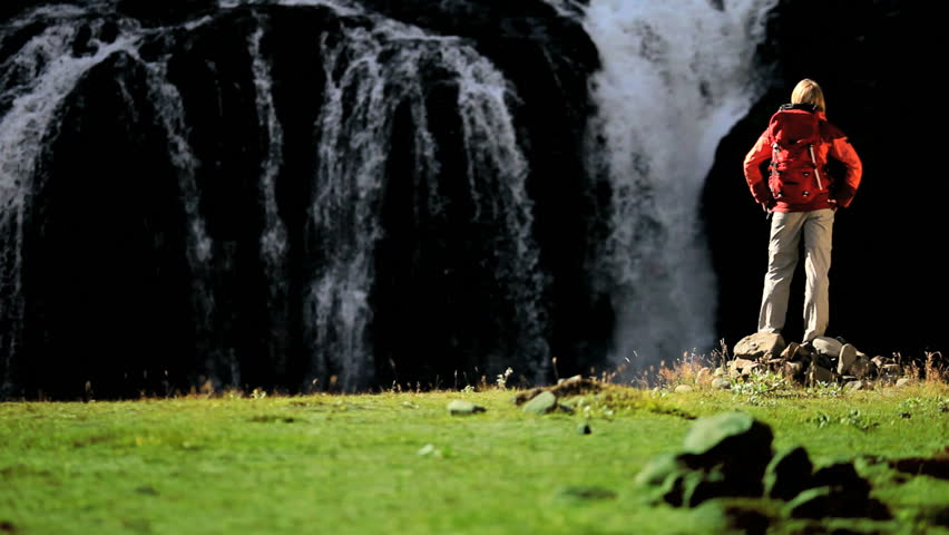 Female by Waterfall on Hiking Expedition