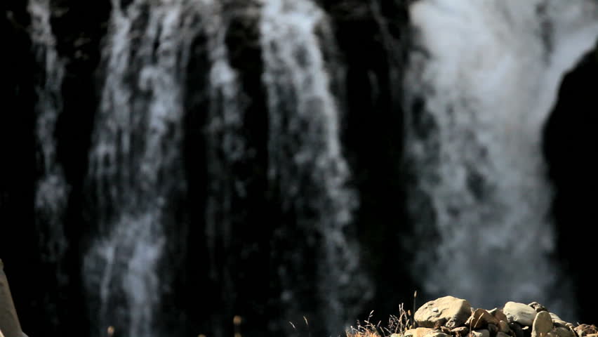 Female Hiker Resting at a Waterfall