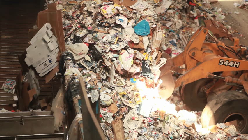 EASTERN U.S. - CIRCA 2008: A bulldozer hauls garbage.