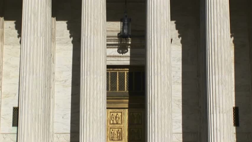 Sunlight reflects on the bright white pillars of the U.S. Supreme Court Building entrance.