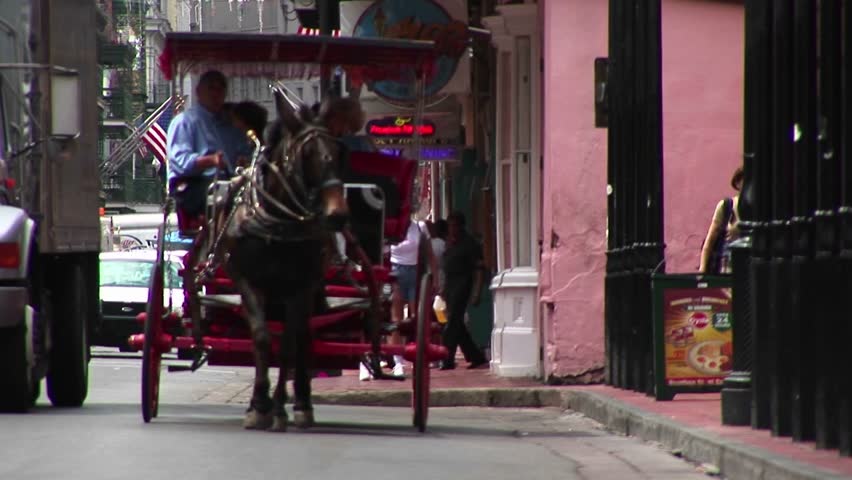 NEW ORLEANS - CIRCA 2009: A mule-drawn buggy makes its way down a crowded street in New Orleans.