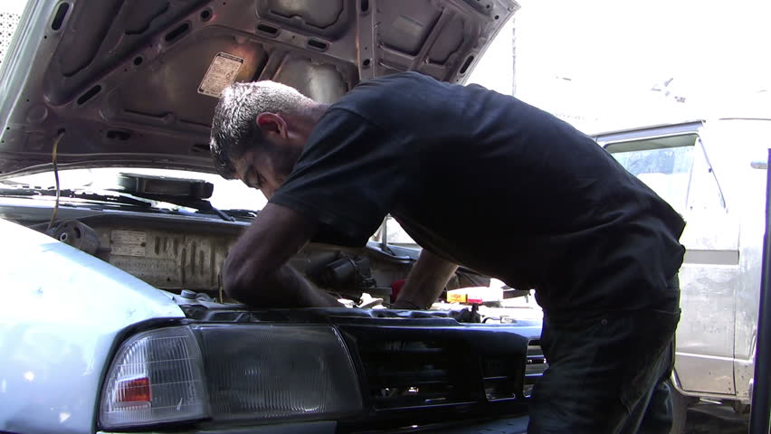 AMMAN, JORDAN -  JUNE 10: An unidentified auto mechanic repairing a car on June 10, 2011 in Amman, Jordan. The value of the industrial exports for year 2005 was about (2379) million; Industrial exports contribute about 93.5% of the national exports.