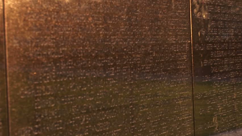 WASHINGTON, D.C. - CIRCA 2009: Close-up of the Vietnam Veterans Memorial Wall with tributes and mementos in front.