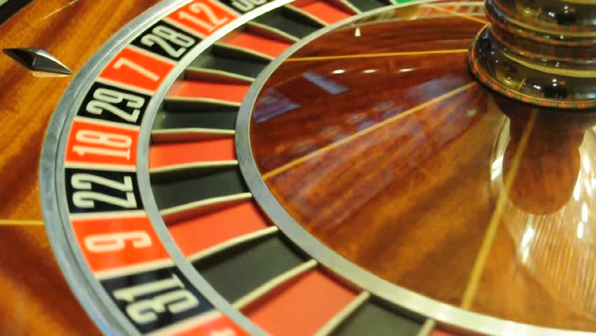 image with a casino roulette wheel with the ball on number 0