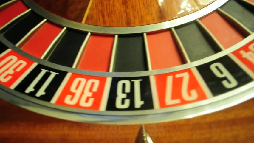 image with a casino roulette wheel with the ball on number 0
