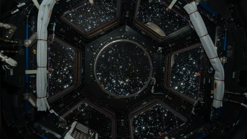Aboard a spaceship traveling though space. 