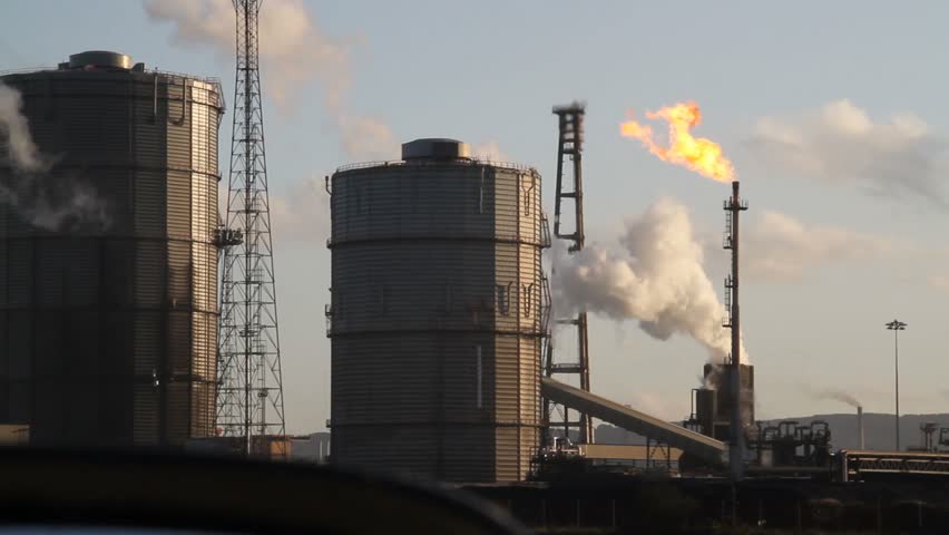 Gas flare lit and steam from quench at a coke oven plant at Redcar on the north east coast of the UK.
