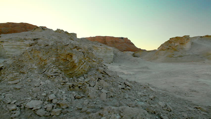 Dolly slider move left to right of rock formations in the desert of the Ein Gedi in Israel.