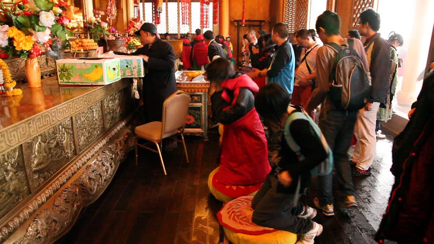 MOUNT EMEI, CHINA - JULY 22, 2009: Buddhists pray inside the Golden Summit Temple on July 22, 2009 on Mount Emei.