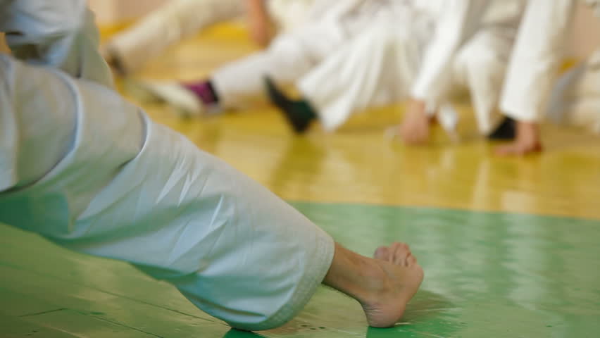 coach at the gym teaches children Martial Art