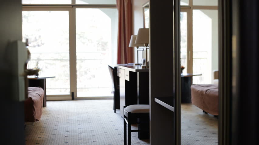 Woman opens a hotel door with a card key 
