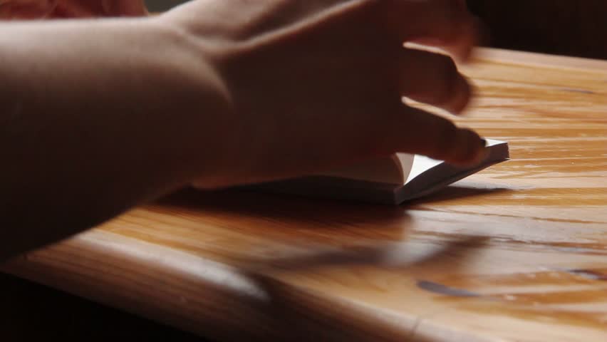 Woman opens checkbook and writes check