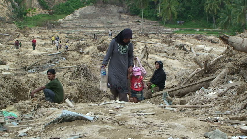 PADANG, INDONESIA - CIRCA OCTOBER 2009: Survivors stand on remains of village wiped out by earthquake induced landslide in Padang, Indonesia circa October 2009.