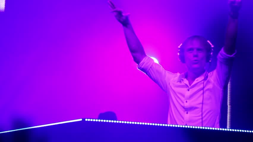 MOSCOW - MAY 6: Popular Dutch DJ Armin Van Buuren on stage with pink blue color light, closeup view on May 6, 2011 in Moscow, Russia.