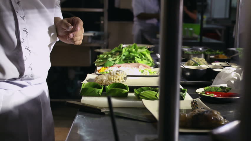 Man at work as chef in the kitchen of an Asian restaurant