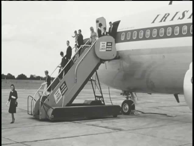 Wide shot passengers disembarking airplane