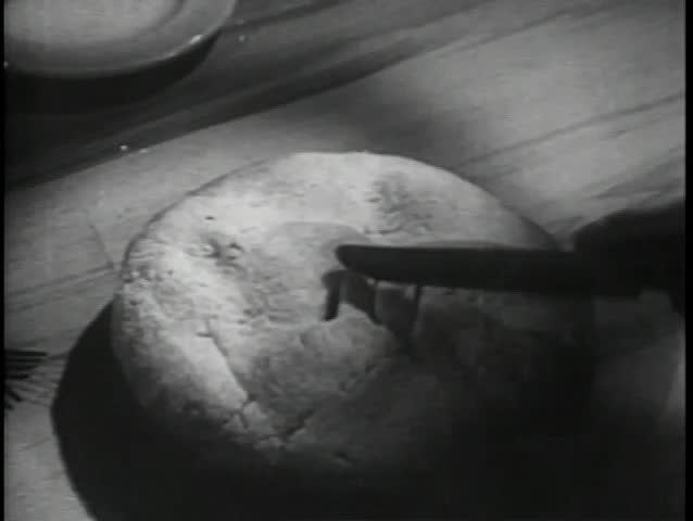 Medium shot hand with knife trying to cut hard pie