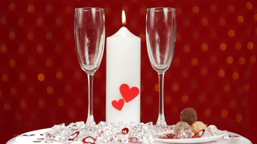 Beginning of a romantic evening. In the beautiful festive glasses poured champagne.