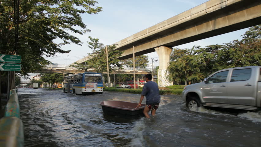 BANGKOK - NOVEMBER 7: People drive on the flooded streets of Bangkok on November 7 during the 2011 floods.